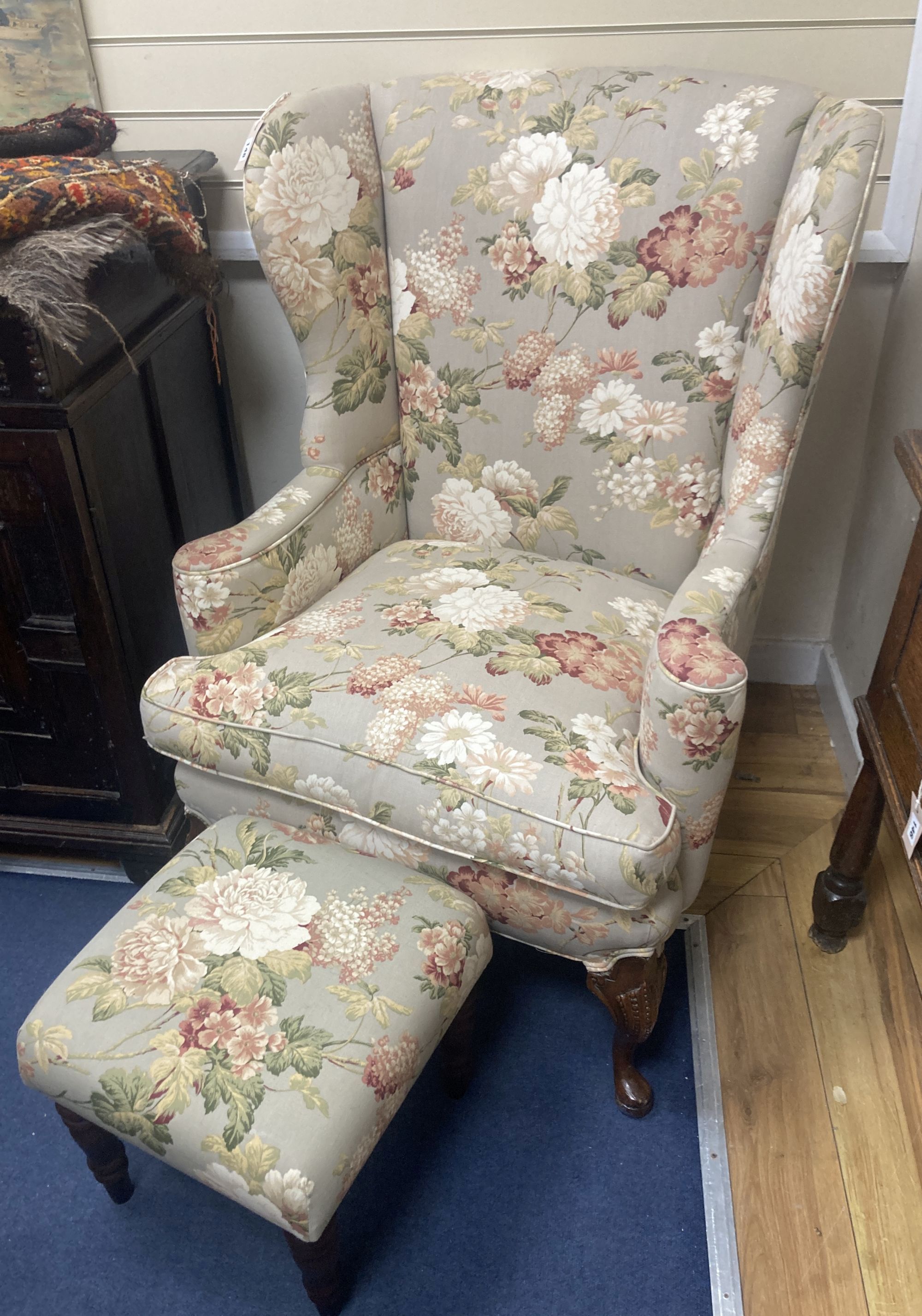 A French Hepplewhite style wing armchair together with a matching contemporary footstool